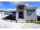 Front entry with modern door and paver walkway at 490 Sorrento Ct, Punta Gorda, FL 33950