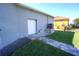 Rear exterior view showing garage and paved pathway at 490 Sorrento Ct, Punta Gorda, FL 33950