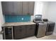 Laundry room with custom cabinetry, granite countertop and wine cooler at 490 Sorrento Ct, Punta Gorda, FL 33950