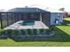 Screened-in pool with paved deck and landscaping at 490 Sorrento Ct, Punta Gorda, FL 33950