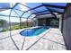 Enclosed patio with kidney-shaped pool and canal view at 490 Sorrento Ct, Punta Gorda, FL 33950