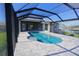 Enclosed patio with kidney-shaped pool and canal view at 490 Sorrento Ct, Punta Gorda, FL 33950