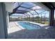 Enclosed patio with kidney-shaped pool and canal view at 490 Sorrento Ct, Punta Gorda, FL 33950