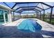 Enclosed patio with kidney-shaped pool and canal view at 490 Sorrento Ct, Punta Gorda, FL 33950