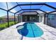 Enclosed patio with kidney-shaped pool and canal view at 490 Sorrento Ct, Punta Gorda, FL 33950