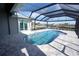 Enclosed patio with kidney-shaped pool and canal view at 490 Sorrento Ct, Punta Gorda, FL 33950