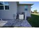 Rear exterior view showing pool equipment and paved patio area at 490 Sorrento Ct, Punta Gorda, FL 33950