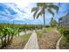 Brick pathway to the waterfront with lush landscaping at 5028 San Massimo Dr, Punta Gorda, FL 33950