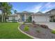 White one-story home with landscaped yard, blue door, and two-car garage at 5028 San Massimo Dr, Punta Gorda, FL 33950