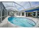 Relaxing kidney-shaped pool with a screened enclosure and spa at 5028 San Massimo Dr, Punta Gorda, FL 33950