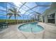 Inviting kidney-shaped pool with a screened enclosure and spa at 5028 San Massimo Dr, Punta Gorda, FL 33950