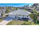 Aerial view of single-story home with tile roof, driveway, and landscaped lawn at 525 Port Bendres Dr, Punta Gorda, FL 33950