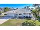 Single-story home with tile roof and landscaped yard in a waterfront community at 525 Port Bendres Dr, Punta Gorda, FL 33950