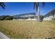 Landscaped backyard with screened enclosure and lush lawn at 525 Port Bendres Dr, Punta Gorda, FL 33950