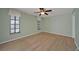 Bedroom with light wood laminate floors and light green walls, featuring a ceiling fan at 525 Port Bendres Dr, Punta Gorda, FL 33950