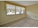 Bedroom with light wood laminate floors and neutral walls, featuring a large window at 525 Port Bendres Dr, Punta Gorda, FL 33950