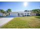 Front view of a single-story home with a well-manicured lawn at 525 Port Bendres Dr, Punta Gorda, FL 33950