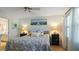 Main bedroom with king-size bed, and access to the bathroom at 5725 Greenwood Ave # 7203, North Port, FL 34287