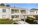 Two-story building with light-colored exterior and stairs at 5725 Greenwood Ave # 7203, North Port, FL 34287