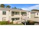 Two-story building with light-colored exterior and stairs at 5725 Greenwood Ave # 7203, North Port, FL 34287