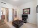 Living room with a view into the bathroom and a comfortable ottoman at 700 Gardens Edge Dr # 722, Venice, FL 34285