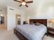 Large main bedroom with a king-size bed and ceiling fan at 700 Gardens Edge Dr # 722, Venice, FL 34285