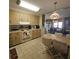 Functional kitchen featuring wood cabinetry, with open layout flowing into the dining area at 735 Blackburn Blvd, North Port, FL 34287