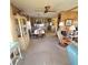 Inviting living area with a ceiling fan, wood paneling, and comfortable furniture at 735 Blackburn Blvd, North Port, FL 34287