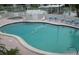 Community pool with surrounding lounge chairs and hot tub at 735 Blackburn Blvd, North Port, FL 34287