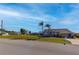 Tan single-Gathering home with palm trees and driveway at 7352 Parkinsonia, Punta Gorda, FL 33955