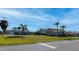 Two-Gathering homes on a residential street with palm trees at 7352 Parkinsonia, Punta Gorda, FL 33955