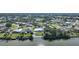 Aerial view of waterfront home in residential neighborhood at 7435 Snow Dr, Englewood, FL 34224