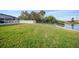 Large grassy backyard, lake view, privacy fence at 7435 Snow Dr, Englewood, FL 34224