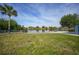 Expansive grassy backyard with lake view at 7435 Snow Dr, Englewood, FL 34224