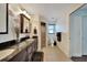 Double vanity bathroom with granite countertops and shower at 7435 Snow Dr, Englewood, FL 34224