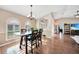 Sunlit dining room featuring a wooden table and chairs, near entryway at 7435 Snow Dr, Englewood, FL 34224