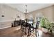 Formal dining room with hardwood floors and elegant chandelier at 7435 Snow Dr, Englewood, FL 34224