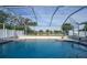 Inviting screened pool with canal view at 7435 Snow Dr, Englewood, FL 34224