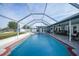 Large screened in pool with surrounding patio at 7435 Snow Dr, Englewood, FL 34224