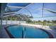 Inviting screened pool with brick coping and patio at 7435 Snow Dr, Englewood, FL 34224