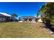 Landscaped backyard with screened pool area at 900 Genoa Ct, Punta Gorda, FL 33950