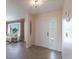 View of the entryway from the living room, showing tiled flooring and a door to the outside at 900 Genoa Ct, Punta Gorda, FL 33950