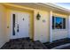 Front door entry with a tiled walkway leading to the house entrance at 900 Genoa Ct, Punta Gorda, FL 33950