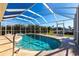 Inviting kidney-shaped pool with screened enclosure at 900 Genoa Ct, Punta Gorda, FL 33950