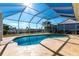 Relaxing kidney-shaped pool with a screened enclosure at 900 Genoa Ct, Punta Gorda, FL 33950