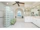 Elegant bathroom with double sinks, a glass-block shower, and a soaking tub at 1014 Francesca Ct, Punta Gorda, FL 33950