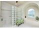 Relaxing bathroom with soaking tub, glass block shower, and tiled floors at 1014 Francesca Ct, Punta Gorda, FL 33950