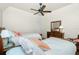 Bright bedroom with two twin beds, ceiling fan, and dresser at 1014 Francesca Ct, Punta Gorda, FL 33950
