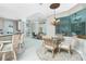 Bright breakfast nook with glass-top table and wicker chairs, overlooking pool at 1014 Francesca Ct, Punta Gorda, FL 33950