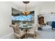 Breakfast nook with glass-top table and wicker chairs, overlooking pool at 1014 Francesca Ct, Punta Gorda, FL 33950